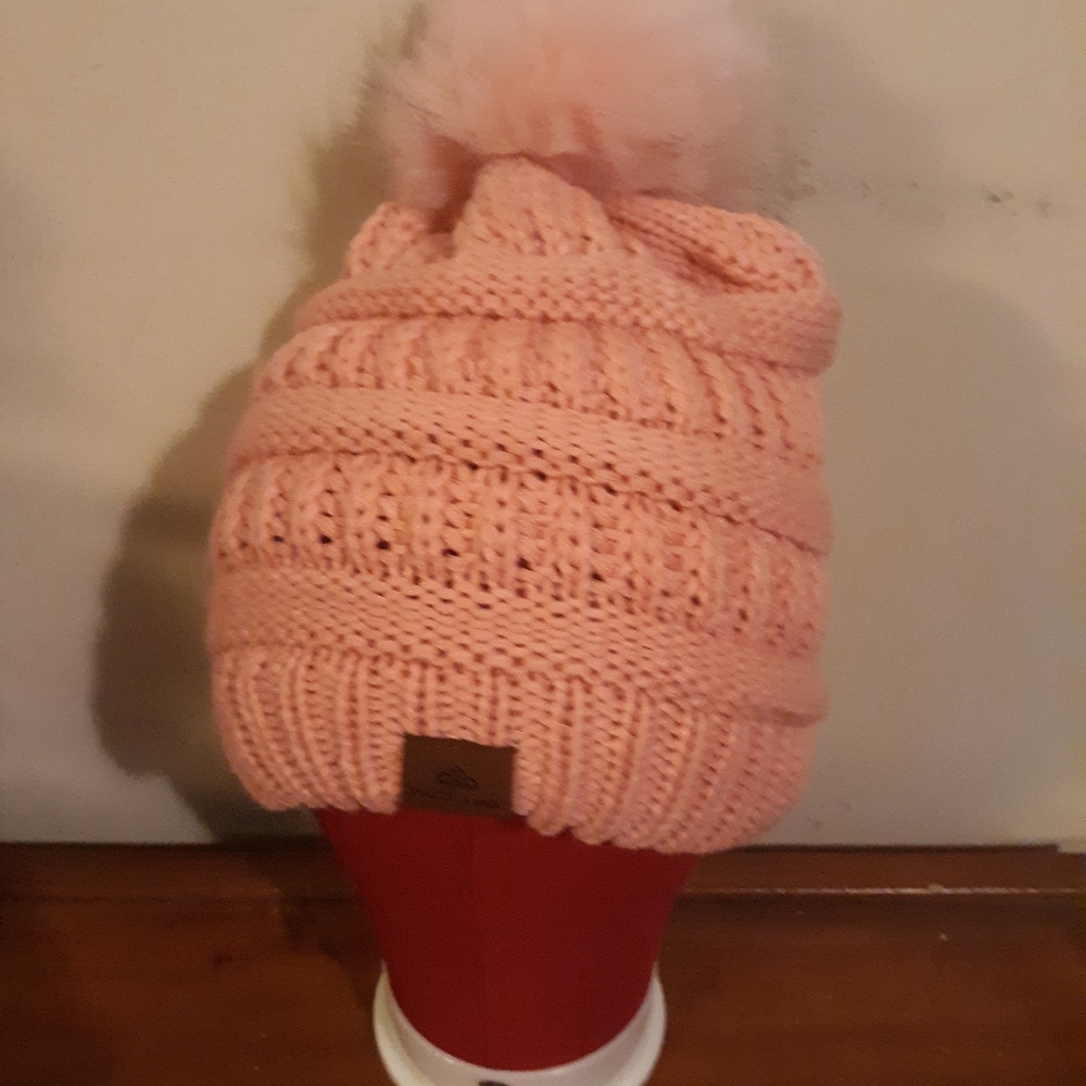 Pink winter hat with furry puff ball top